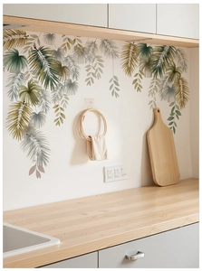Detailed close-up of tropical palm leaf wall stickers in a modern kitchen setting