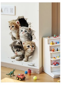 Detail of 3D cat wall stickers showing four kittens peeking through a broken wall effect