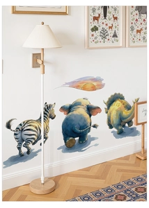 Detailed view of zebra, elephant, and triceratops wall decals with a colorful sunset