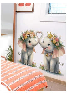 Close-up of cute cartoon elephant wall stickers with floral wreaths in a child nursery