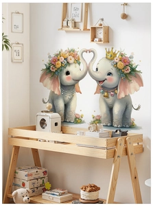 Detail of two cartoon elephants with floral wreaths forming a heart shape on a wall