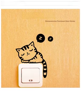 Removable black sleeping cat wall sticker with Z bubbles above a white light switch