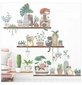 Cute cartoon cats and potted plants wall decals displayed above a pink sofa in a cozy room