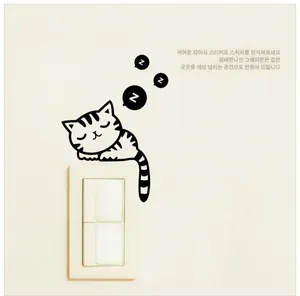 Detail view of a sleeping cat wall sticker applied above a light switch panel