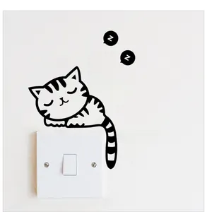 Detailed close-up of a sleeping cat wall decal placed above a white light switch panel