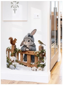 Detailed view of removable winter rabbit wall stickers on a clean white interior wall