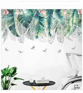Detail showing tropical monstera leaf wall stickers with dragonflies in a bedroom