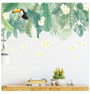 Detailed wall sticker featuring tropical monstera leaves and a toucan in a cozy room
