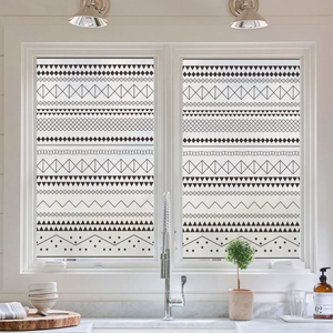 Frosted window privacy film with black Moroccan geometric patterns on a bathroom window
