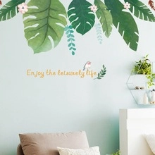 Detail of tropical plant wall decal with bird and Enjoy the leisurely life quote