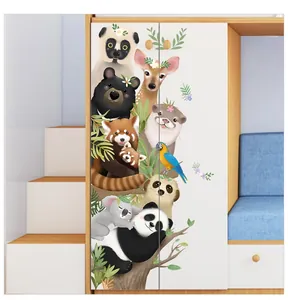 Detailed close-up of hand-drawn cartoon animal stickers on a white nursery wardrobe