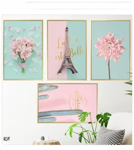 Detail of four-piece Nordic wall art set with pink flowers and golden frames in modern interior