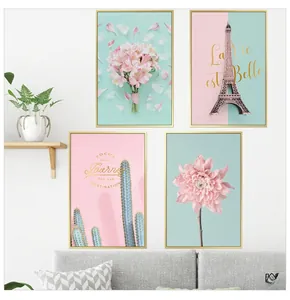 Close-up of a 4-piece set of Nordic pink wall art with golden frames and floral themes