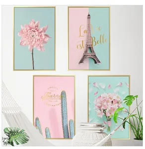 Detail of four Nordic wall art pieces with pink floral motifs and gold metal frames