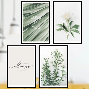Set of 4 white floral and green leaf wall art prints with black frames in Nordic style