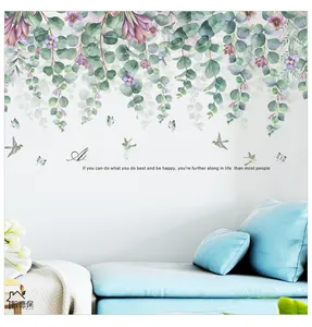Macro shot of tropical eucalyptus leaf wall decals with floral accents and flying birds