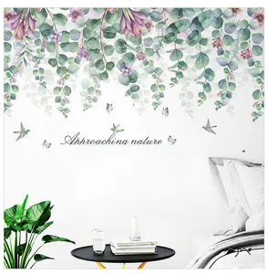 Detail of watercolor tropical leaves and bird wall stickers in a cozy bedroom setting
