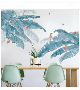 Detail of Nordic banana leaf wall sticker with blue leaves and birds in dining room