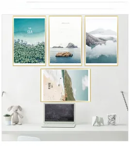 Modern minimalist four-panel scenic wall art with thin gold frames in a home office setup