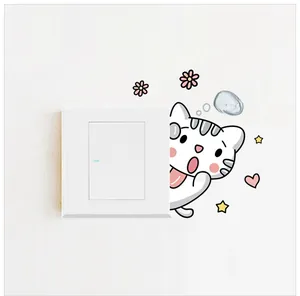 Close-up of cute cartoon cat and stars stickers applied next to a white light switch