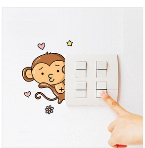 Detail of cartoon monkey wall sticker with hearts and stars around a light switch