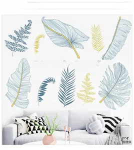 Detail of blue and gold tropical leaf wall decals with The leaves are flying text decoration