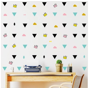 Detail of Nordic wall stickers with colorful triangles and crowns on a clean white wall