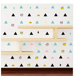 Minimalist wall stickers with colorful triangles, crowns, and clouds in a Nordic home scene
