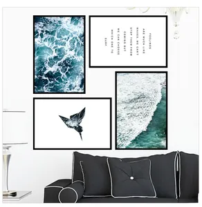 Detailed view of four-piece blue ocean waves and hummingbird wall art set in black frames