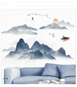 Detailed view of ink mountain landscape wallpaper with artistic birds and sun on blue sofa wall