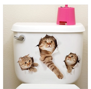 Three lifelike 3D tabby cat wall stickers showing a realistic tearing effect on a white toilet