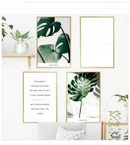 Detail of Nordic monstera plant wall art set with gold frames in a modern living room