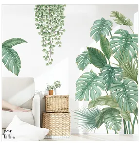Detail of tropical monstera leaf wall decals on a white wall in a modern living room decor
