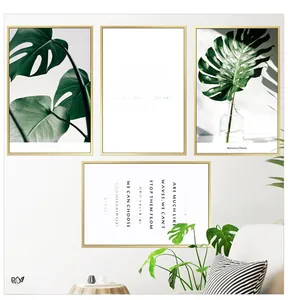 Modern wall art set with monstera leaf prints and inspirational quotes in gold frames