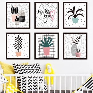 Minimalist black framed wall art set with Nordic potted plants for a modern nursery decor