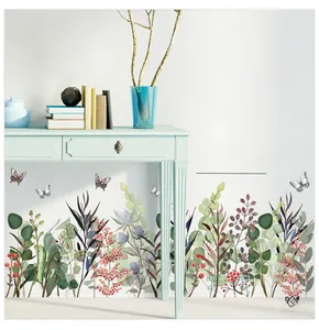Detail of watercolor green leaves and red berries wall sticker as a baseboard decoration