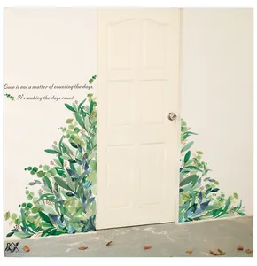 Detail of green eucalyptus leaf wall stickers and inspirational quote for home decor