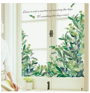 Detail of green leaf wall stickers with inspiring quote on glass window decor