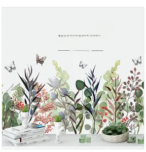 Detail showing green leaves and butterfly wall stickers in a minimalist Nordic home setting
