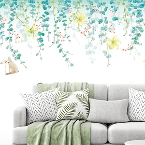 Modern Nordic green leaf wall sticker mural above a minimalist sofa in a cozy living room