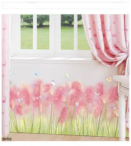 Detail of pink watercolor reed wall stickers with butterflies on a home window background
