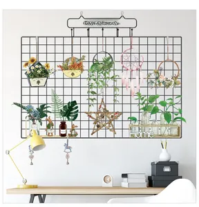 Industrial black metal wall grid organizer with Home wooden shelf and floral decor