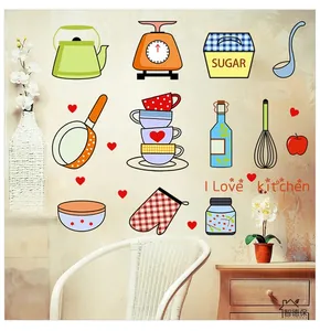 Detail view of cartoon kitchen wall decals showing kettle, scale, and pan stickers