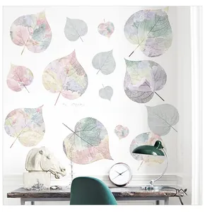 Detail of leaf wall decals with inspirational quote on a minimalist white wall decor