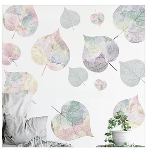 Close-up of artistic pastel leaf vein wall stickers with quote in a bedroom setting