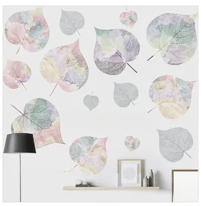 Detail of dreamlike leaf wall decals in pastel colors for bedroom decor on a white wall