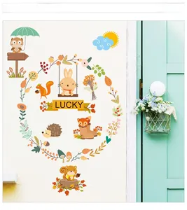 Detail of forest animal wall stickers with owls and foxes on a white nursery door