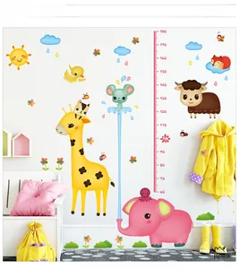 Detailed view of cartoon giraffe height chart wall sticker applied to white interior wall