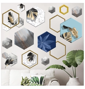 Detail of self-adhesive hexagonal wall stickers with marble and gold tropical leaf patterns