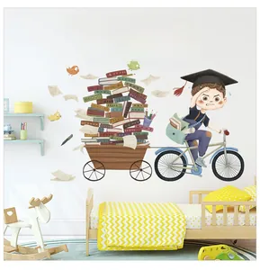 Detail of inspirational cartoon wall sticker showing a boy on a bike with colorful books